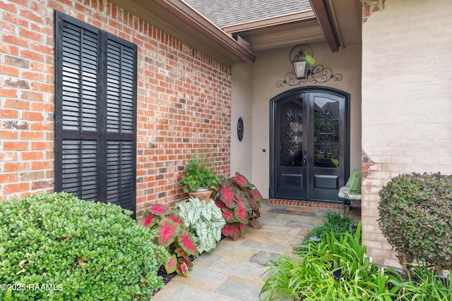 104 Baltimore Ln, Lafayette, LA 70506 - doorway to property featuring french doors, brick siding, a shingled roof, and stucco siding