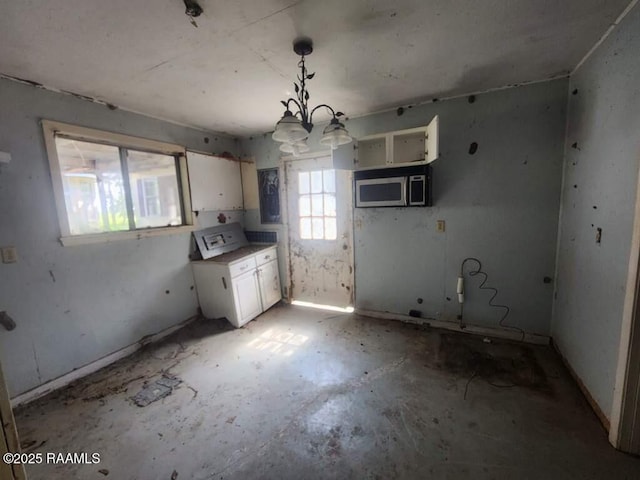 37208 Monceaux Rd, Gueydan, LA 70542 - kitchen featuring white cabinets, stainless steel microwave, a chandelier, and pendant lighting