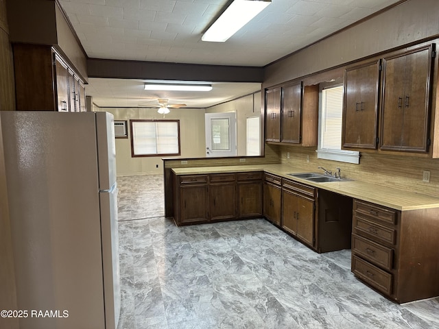 1002 Vidrine St, Opelousas, LA 70570 - kitchen with freestanding refrigerator, a sink, light countertops, and a ceiling fan