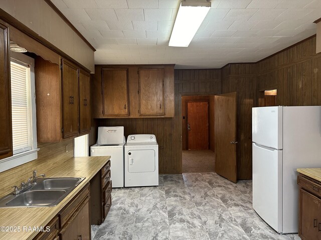 1002 Vidrine St, Opelousas, LA 70570 - washroom with wood walls and washer and clothes dryer