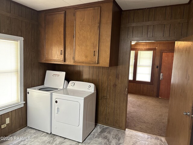 1002 Vidrine St, Opelousas, LA 70570 - washroom with wood walls, washing machine and clothes dryer, and cabinet space