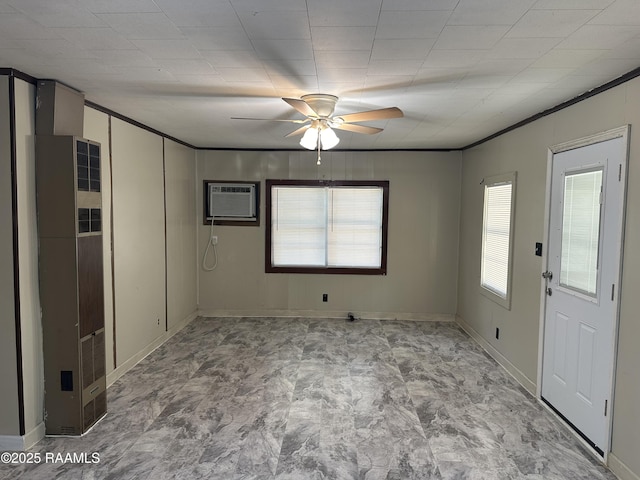 1002 Vidrine St, Opelousas, LA 70570 - empty room with a heating unit, ceiling fan, an AC wall unit, baseboards, and ornamental molding