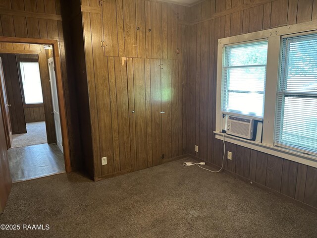 1002 Vidrine St, Opelousas, LA 70570 - unfurnished bedroom with a closet, wood walls, carpet flooring, and cooling unit