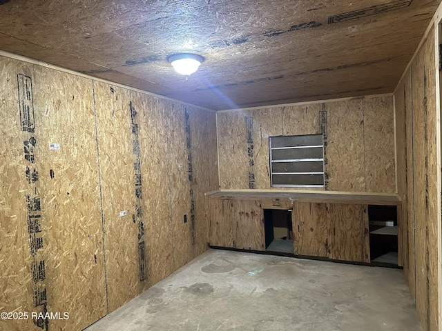 1002 Vidrine St, Opelousas, LA 70570 - spare room with unfinished concrete flooring and wooden walls