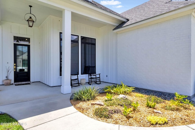 307 Harvest Creek Ln, Lafayette, LA 70508 - entrance to property featuring covered porch, a shingled roof, and board and batten siding