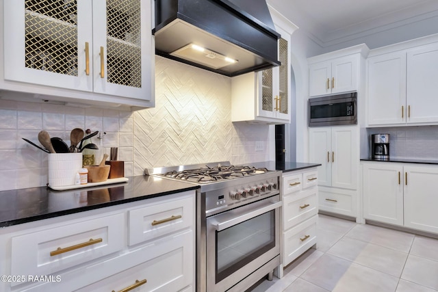 307 Harvest Creek Ln, Lafayette, LA 70508 - kitchen featuring stainless steel appliances, custom range hood, tasteful backsplash, dark countertops, and white cabinets