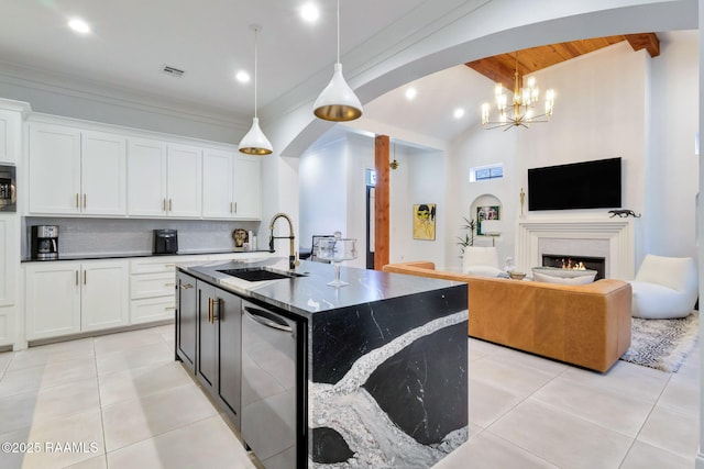 307 Harvest Creek Ln, Lafayette, LA 70508 - kitchen featuring light tile patterned floors, arched walkways, decorative backsplash, white cabinetry, and recessed lighting