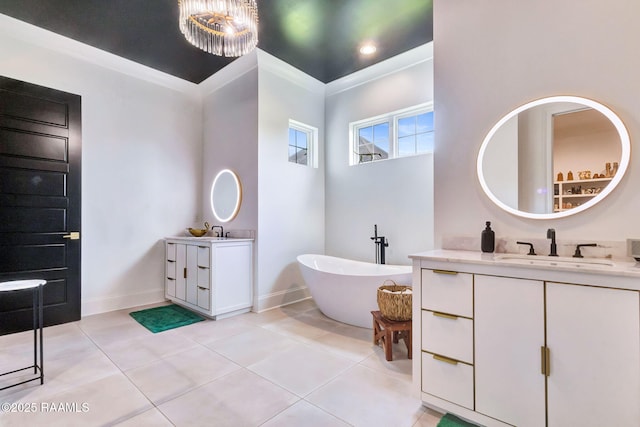 307 Harvest Creek Ln, Lafayette, LA 70508 - full bathroom with two vanities, a freestanding tub, and tile patterned floors