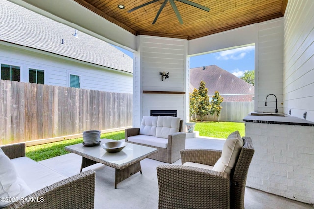307 Harvest Creek Ln, Lafayette, LA 70508 - fenced backyard featuring a ceiling fan, an outdoor living space with a fireplace, and a patio area