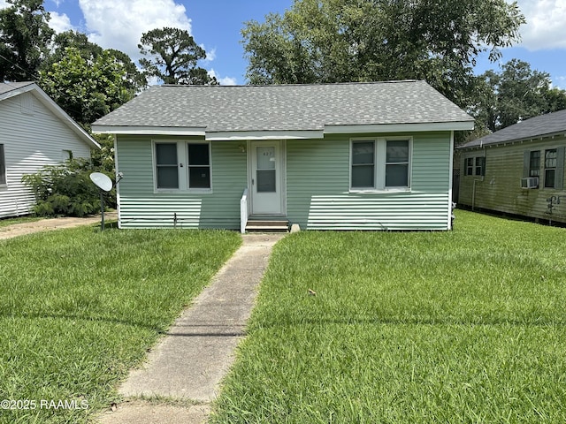 627 S Railroad Ave, Opelousas, LA 70570 - view of front facade with entry steps, a shingled roof, a front yard, and cooling unit