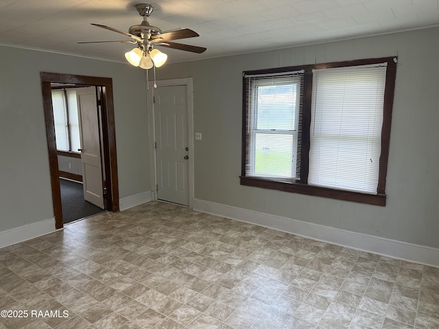 627 S Railroad Ave, Opelousas, LA 70570 - unfurnished room with ceiling fan, baseboards, crown molding, and stone finish floors