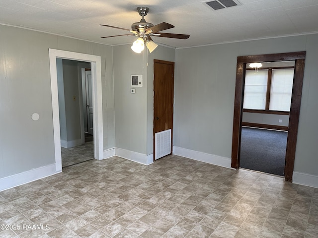 627 S Railroad Ave, Opelousas, LA 70570 - unfurnished room featuring crown molding, baseboards, a ceiling fan, and stone finish flooring