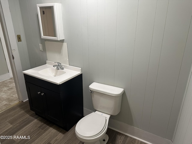 627 S Railroad Ave, Opelousas, LA 70570 - bathroom with vanity, toilet, wood finished floors, and baseboards
