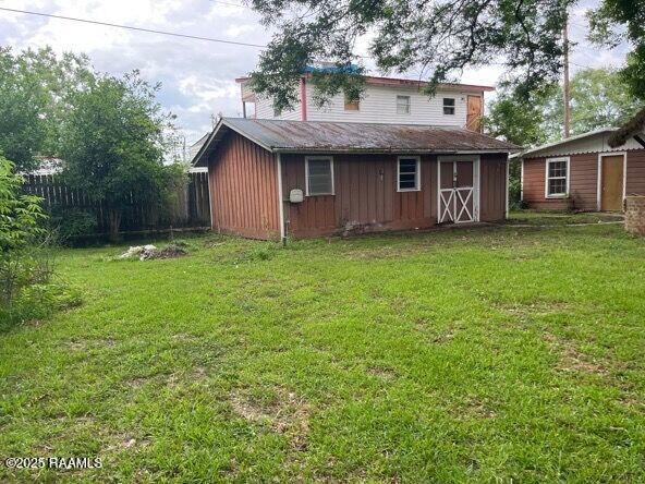 109 Pecan St, Ville Platte, LA 70586 - rear view of property with an outbuilding and board and batten siding
