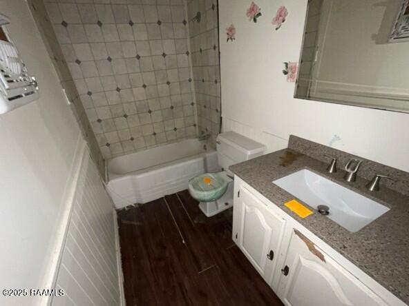109 Pecan St, Ville Platte, LA 70586 - full bath with vanity, wood finished floors, toilet, and bathing tub / shower combination