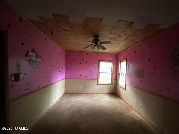 109 Pecan St, Ville Platte, LA 70586 - empty room featuring wainscoting, carpet floors, and a ceiling fan