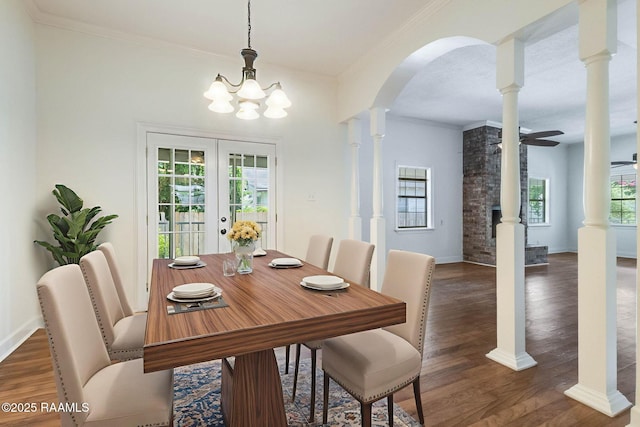 315 Tissington St, Lafayette, LA 70501 - dining room with arched walkways, wood finished floors, crown molding, a chandelier, and french doors