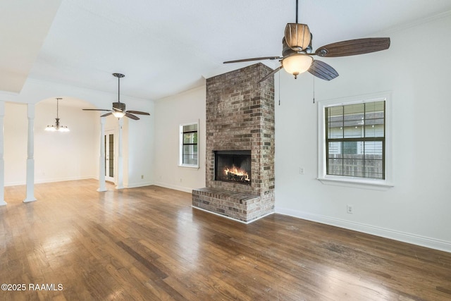 315 Tissington St, Lafayette, LA 70501 - unfurnished living room featuring ceiling fan, a chandelier, a fireplace, wood finished floors, and crown molding