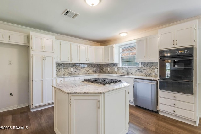 315 Tissington St, Lafayette, LA 70501 - kitchen featuring appliances with stainless steel finishes, a warming drawer, a sink, dark wood-style floors, and tasteful backsplash
