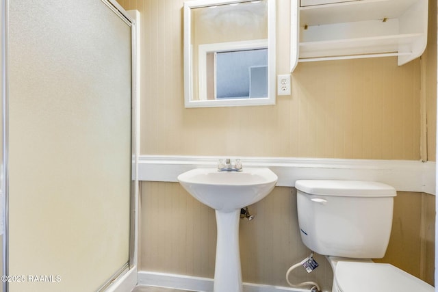 315 Tissington St, Lafayette, LA 70501 - bathroom featuring toilet, a shower stall, and wood walls