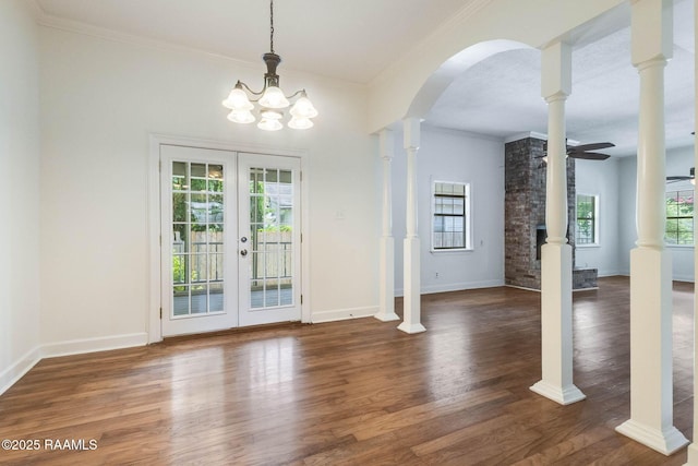 315 Tissington St, Lafayette, LA 70501 - unfurnished dining area featuring arched walkways, french doors, wood finished floors, ornamental molding, and ceiling fan