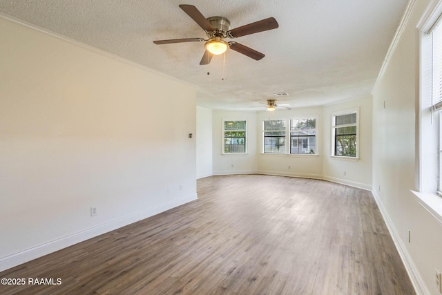315 Tissington St, Lafayette, LA 70501 - spare room with a ceiling fan, wood finished floors, crown molding, baseboards, and a textured ceiling