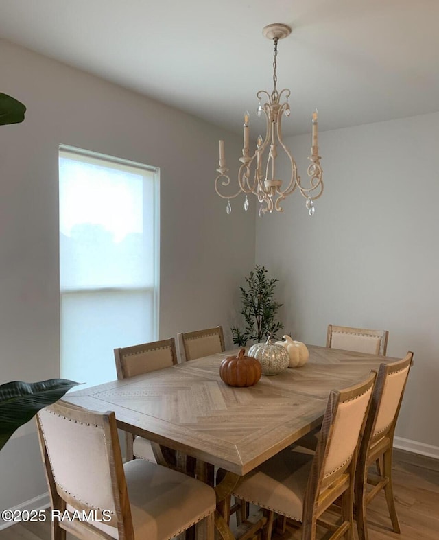 209 Crescent View Ln, Duson, LA 70529 - dining room featuring a chandelier, wood finished floors, and baseboards