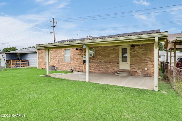 1521 Saint Jude Ave, New Iberia, LA 70560 - back of property with a fenced backyard, entry steps, brick siding, a patio, and ceiling fan