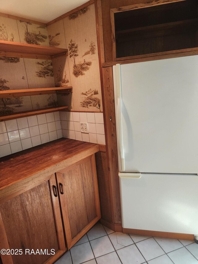 101 Hidden Hills Lake Rd, Arnaudville, LA 70512 - kitchen with freestanding refrigerator, butcher block countertops, brown cabinetry, light tile patterned floors, and open shelves