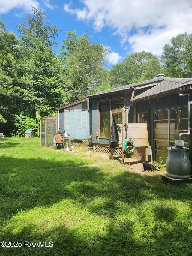 101 Hidden Hills Lake Rd, Arnaudville, LA 70512 - back of house with a yard and exterior structure