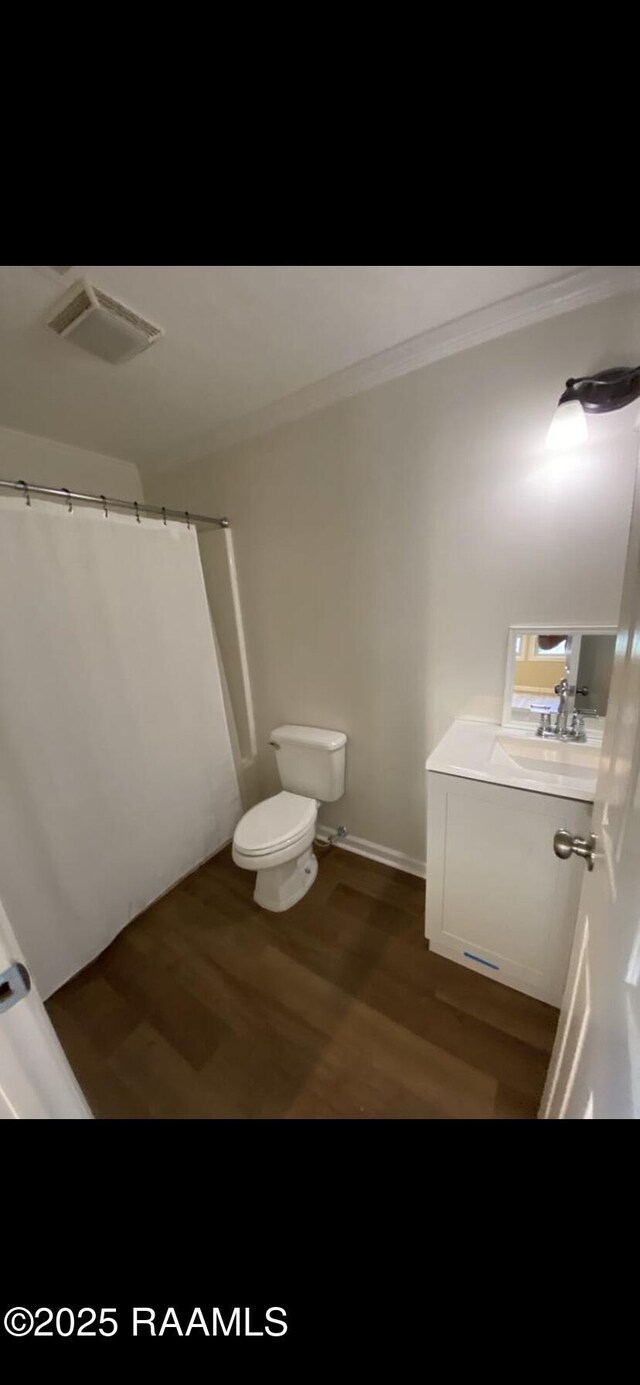 232 Mills St, Scott, LA 70583 - full bathroom with vanity, wood finished floors, and a shower with curtain