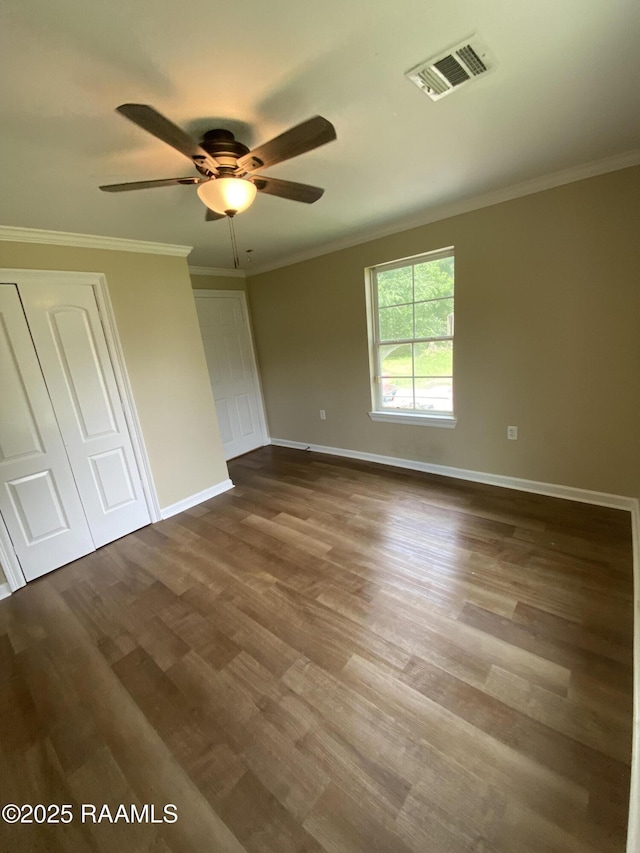 232 Mills St, Scott, LA 70583 - unfurnished bedroom featuring dark wood-type flooring, crown molding, and a ceiling fan