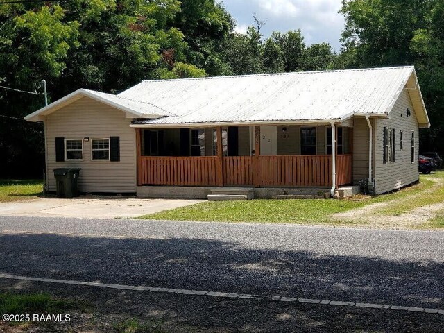 232 Mills St, Scott, LA 70583 - single story home featuring a porch and a metal roof