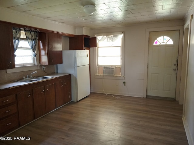 1502 Cherokee St, Abbeville, LA 70510 - kitchen with freestanding refrigerator, a sink, dark wood-style flooring, cooling unit, and light countertops