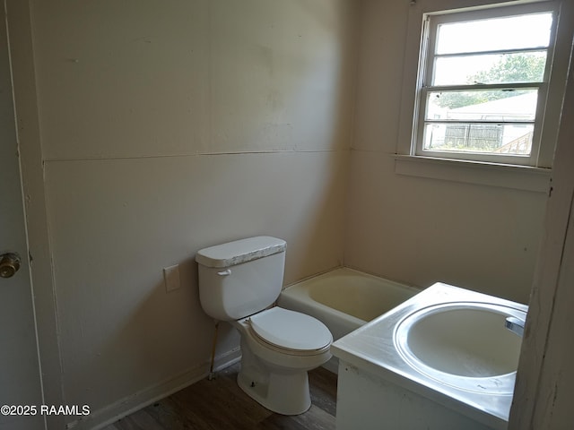 1502 Cherokee St, Abbeville, LA 70510 - full bathroom featuring toilet, a tub to relax in, wood finished floors, and vanity