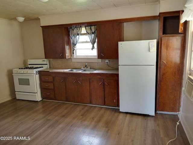 1502 Cherokee St, Abbeville, LA 70510 - kitchen with white appliances, a sink, dark wood finished floors, and light countertops