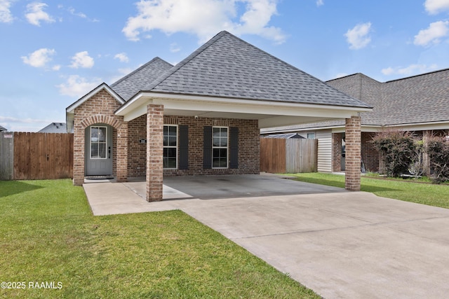 310 Harvest Ln, Abbeville, LA 70510 - view of front of property with a shingled roof, driveway, brick siding, and a carport