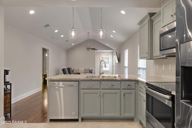 310 Harvest Ln, Abbeville, LA 70510 - kitchen featuring appliances with stainless steel finishes, a peninsula, vaulted ceiling, a ceiling fan, and recessed lighting