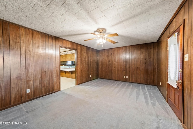 1530 S Fieldspan Rd, Duson, LA 70529 - unfurnished room featuring a ceiling fan, light carpet, and wooden walls