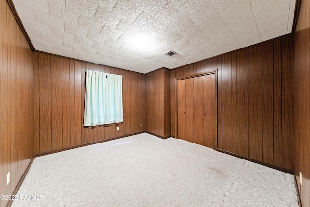 1530 S Fieldspan Rd, Duson, LA 70529 - unfurnished bedroom featuring carpet floors, a closet, and wood walls