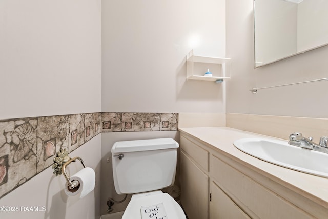 1530 S Fieldspan Rd, Duson, LA 70529 - half bath featuring vanity, a wainscoted wall, and tile walls