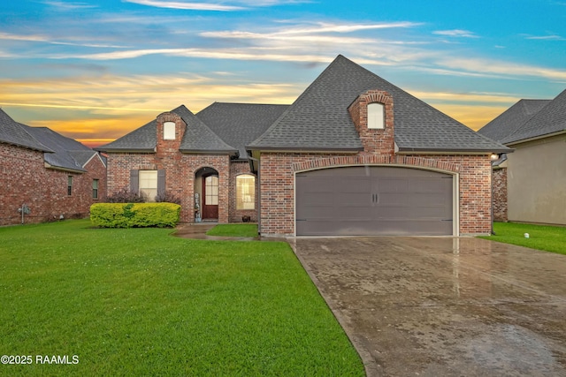 105 Cane Creek Dr, Broussard, LA 70518 - french country home featuring a shingled roof, brick siding, a yard, and driveway