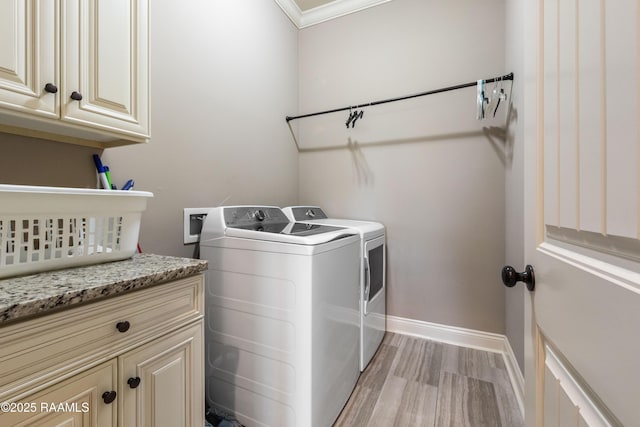 105 Cane Creek Dr, Broussard, LA 70518 - laundry area with washing machine and dryer, cabinet space, light wood-style floors, and ornamental molding