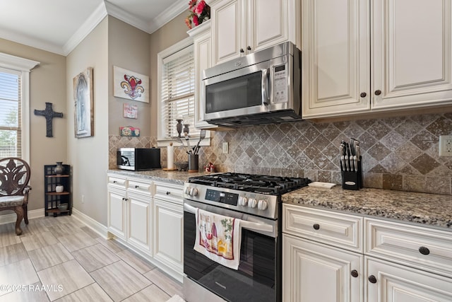 105 Cane Creek Dr, Broussard, LA 70518 - kitchen with appliances with stainless steel finishes, backsplash, light stone counters, and ornamental molding