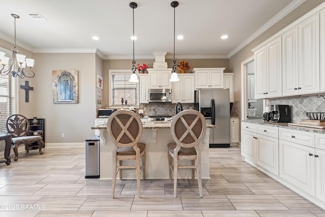 105 Cane Creek Dr, Broussard, LA 70518 - kitchen featuring appliances with stainless steel finishes, tasteful backsplash, a kitchen island with sink, a chandelier, and crown molding