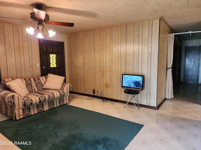 2115 Vige St, Opelousas, LA 70570 - living room with light floors, ceiling fan, wood walls, and baseboards