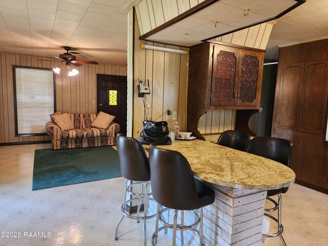 2115 Vige St, Opelousas, LA 70570 - dining area with light flooring, wood walls, and ceiling fan
