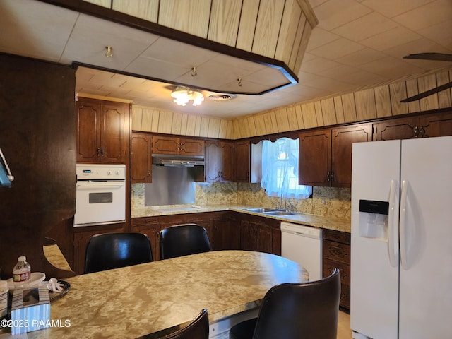 2115 Vige St, Opelousas, LA 70570 - kitchen featuring white appliances, a sink, light countertops, tasteful backsplash, and under cabinet range hood