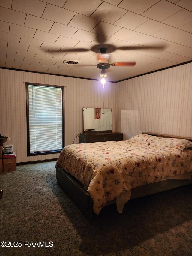2115 Vige St, Opelousas, LA 70570 - carpeted bedroom with wallpapered walls and ceiling fan