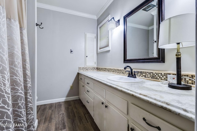 938 Marteau Rd, Broussard, LA 70518 - bathroom with vanity, wood finished floors, decorative backsplash, crown molding, and baseboards